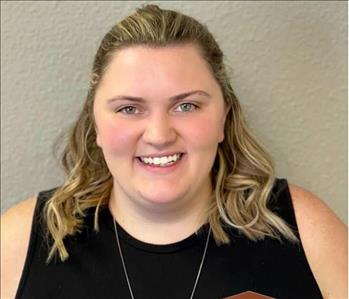 Female employee in front of gray background