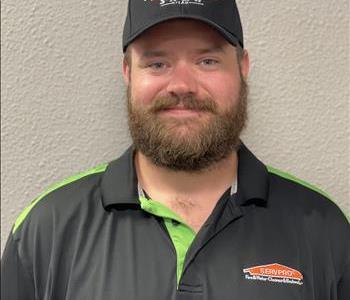 Male employee in front of gray background